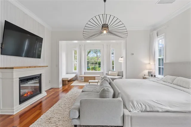 a bedroom with a bed and painting on the wall