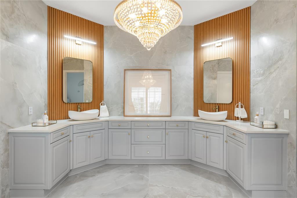 222 Acadia Terrace Celebration, FL 34747 - Photo 26 of 76 a spacious bathroom with a double vanity sink a mirror and a