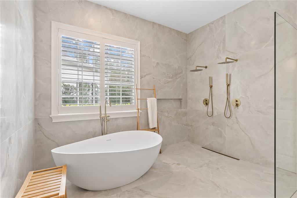 222 Acadia Terrace Celebration, FL 34747 - Photo 28 of 76 a bathroom with a bathtub and shower