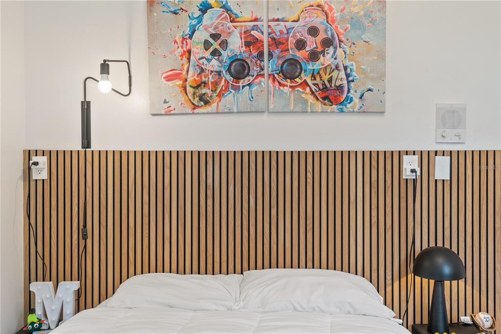 222 Acadia Terrace Celebration, FL 34747 - Photo 35 of 76 a bedroom with a bed and painting on the wall