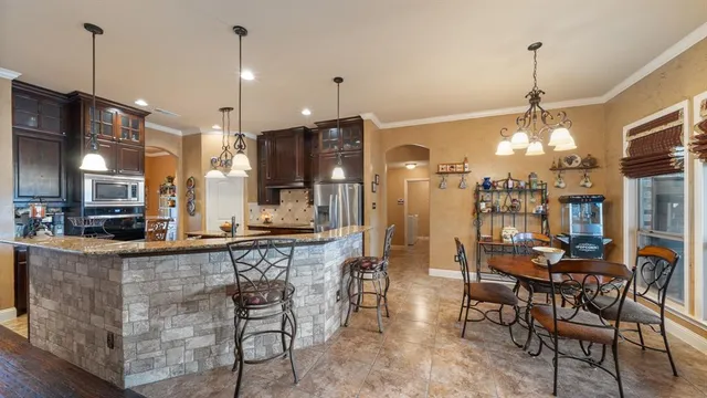 a large kitchen with a table and chairs