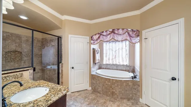 a bathroom with a granite countertop sink a mirror and a shower