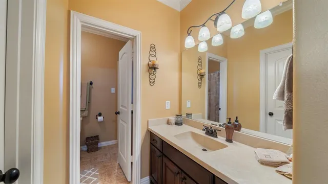 a bathroom with a sink vanity granite tub and shower