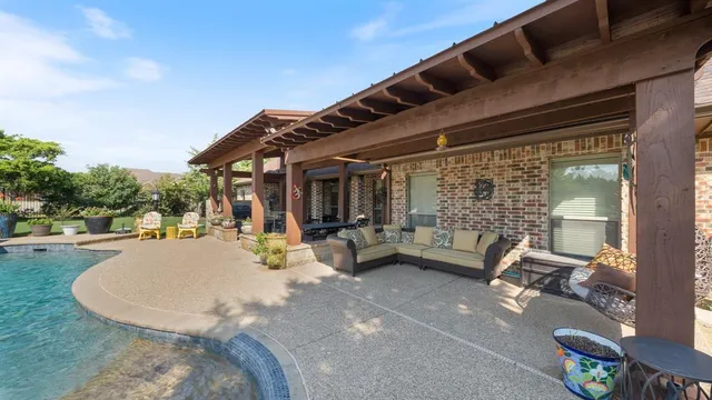 a view of a patio with couches table and chairs and potted plants