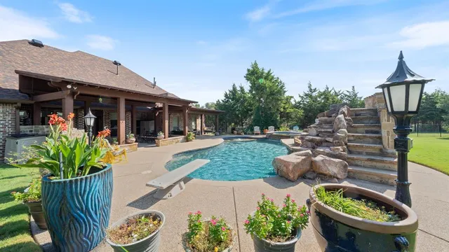 a view of a chair and table in backyard of the house