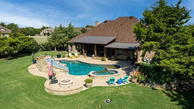 a aerial view of a house with swimming pool garden and patio