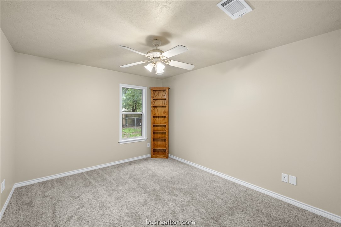 2287 North Earl Rudder Freeway Bryan, TX 77803 - Photo 14 of 32 an empty room with a ceiling fan and a window