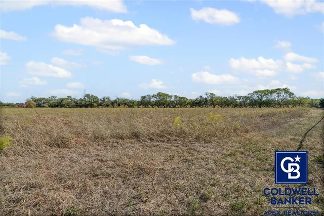 a view of a lake with houses in the back