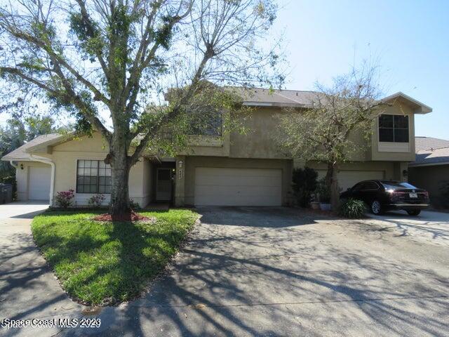 465 Arbor Ridge Lane Titusville, FL 32780 - Photo 1 of 13 a front view of a house with garden