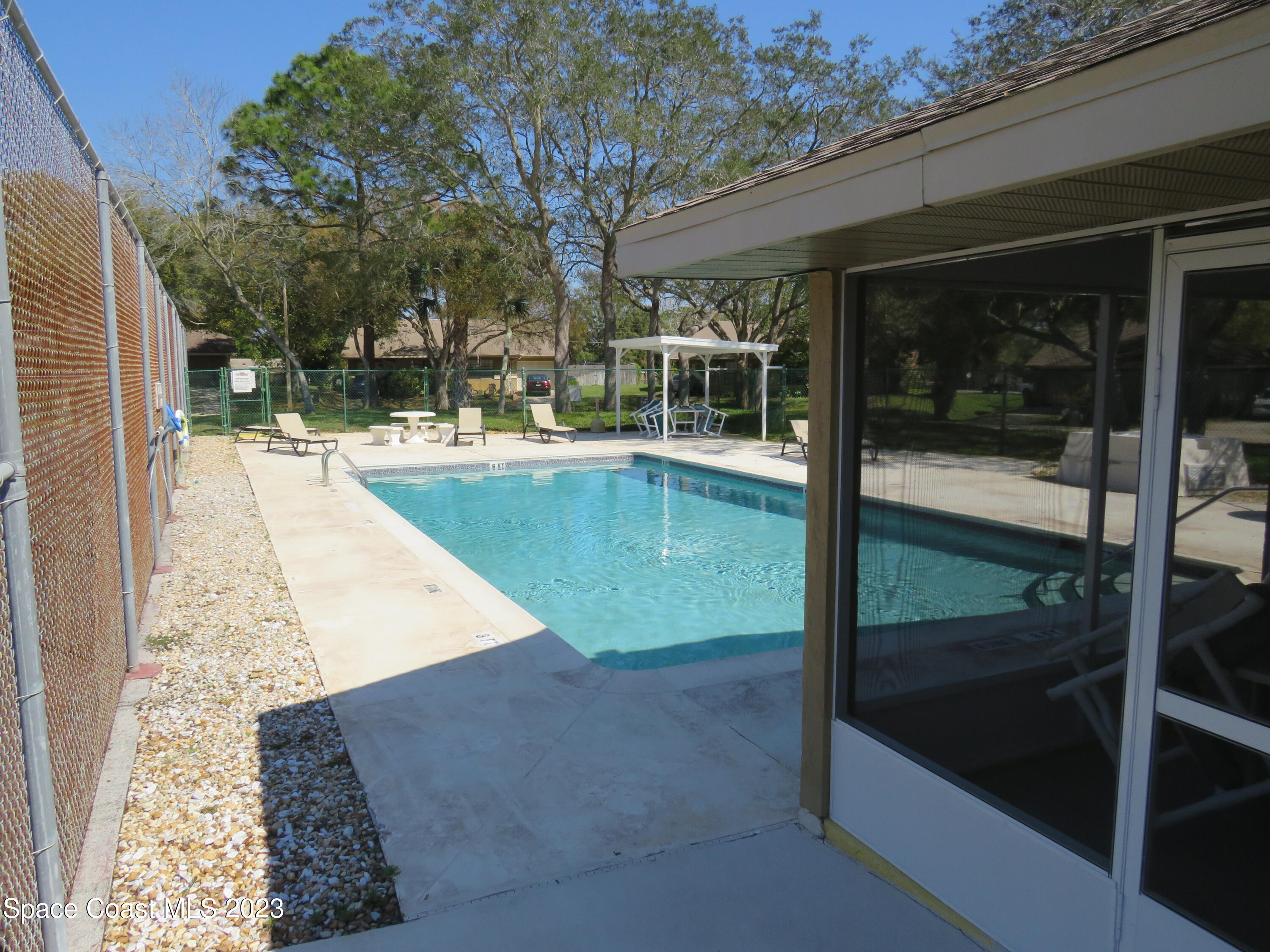 465 Arbor Ridge Lane Titusville, FL 32780 - Photo 12 of 13 a view of a swimming pool with sitting area