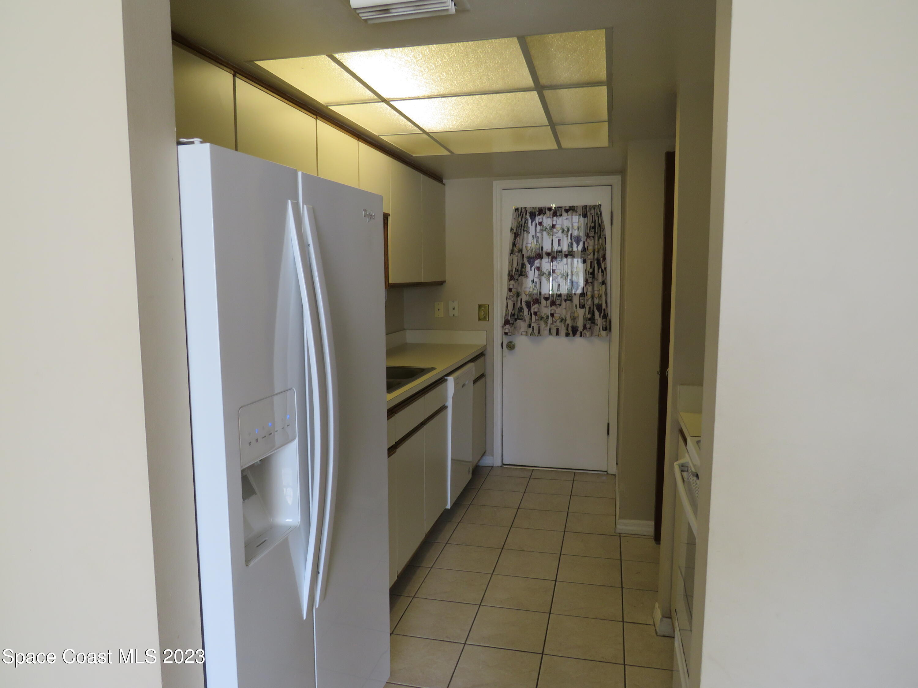 465 Arbor Ridge Lane Titusville, FL 32780 - Photo 2 of 13 a kitchen with a refrigerator and a stove