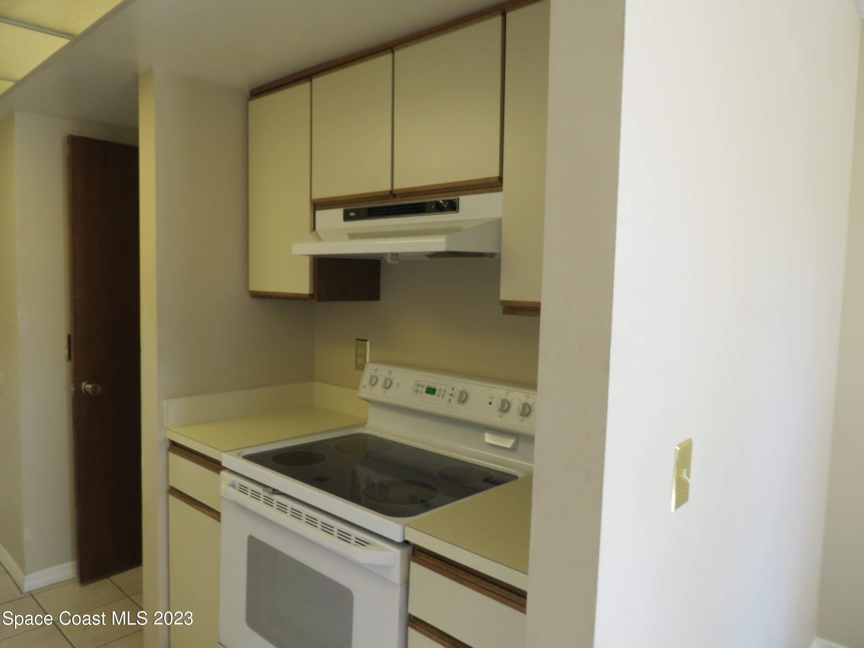 465 Arbor Ridge Lane Titusville, FL 32780 - Photo 3 of 13 a kitchen with a stove and a microwave