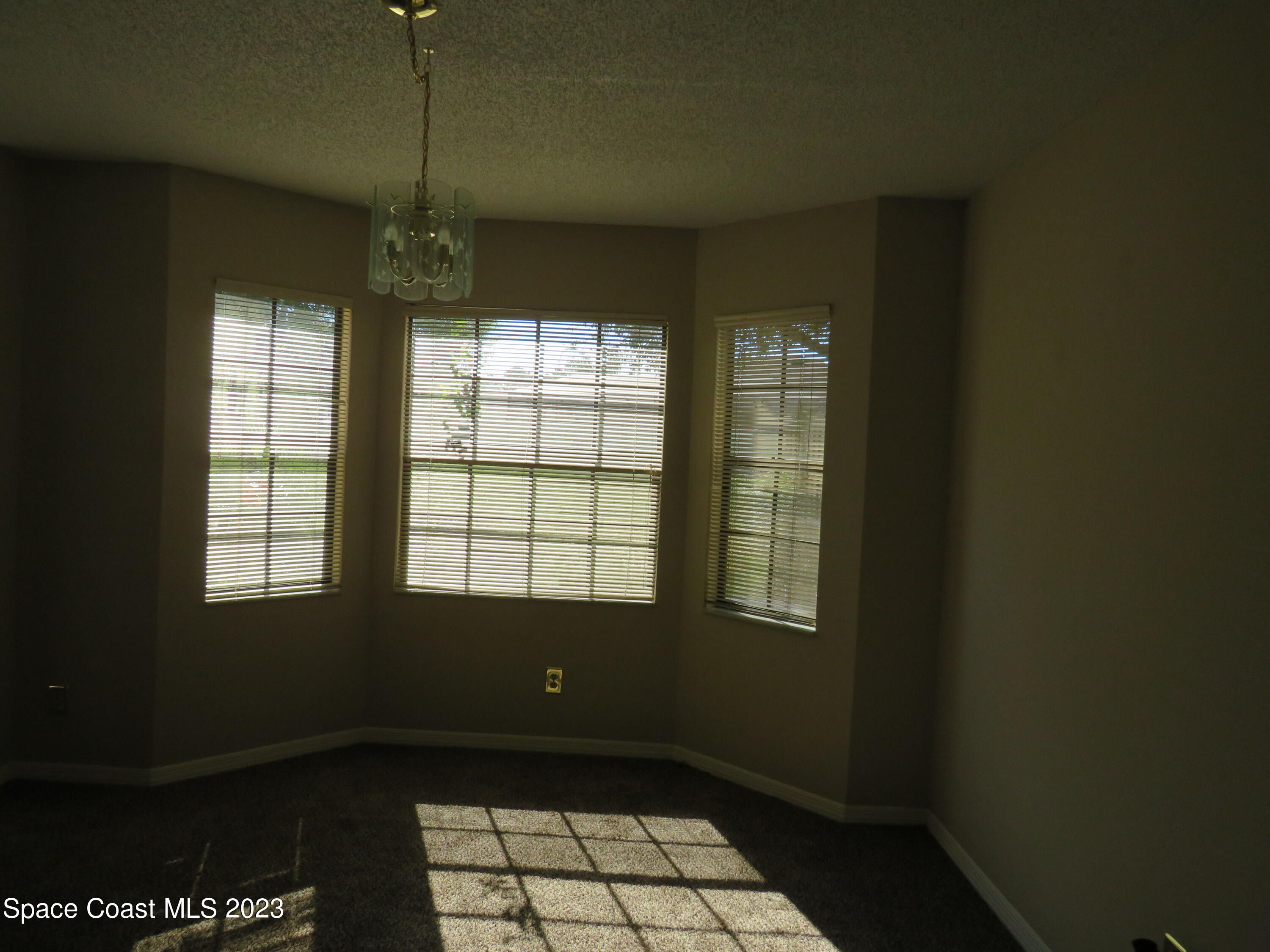 465 Arbor Ridge Lane Titusville, FL 32780 - Photo 4 of 13 a view of an empty room with a window