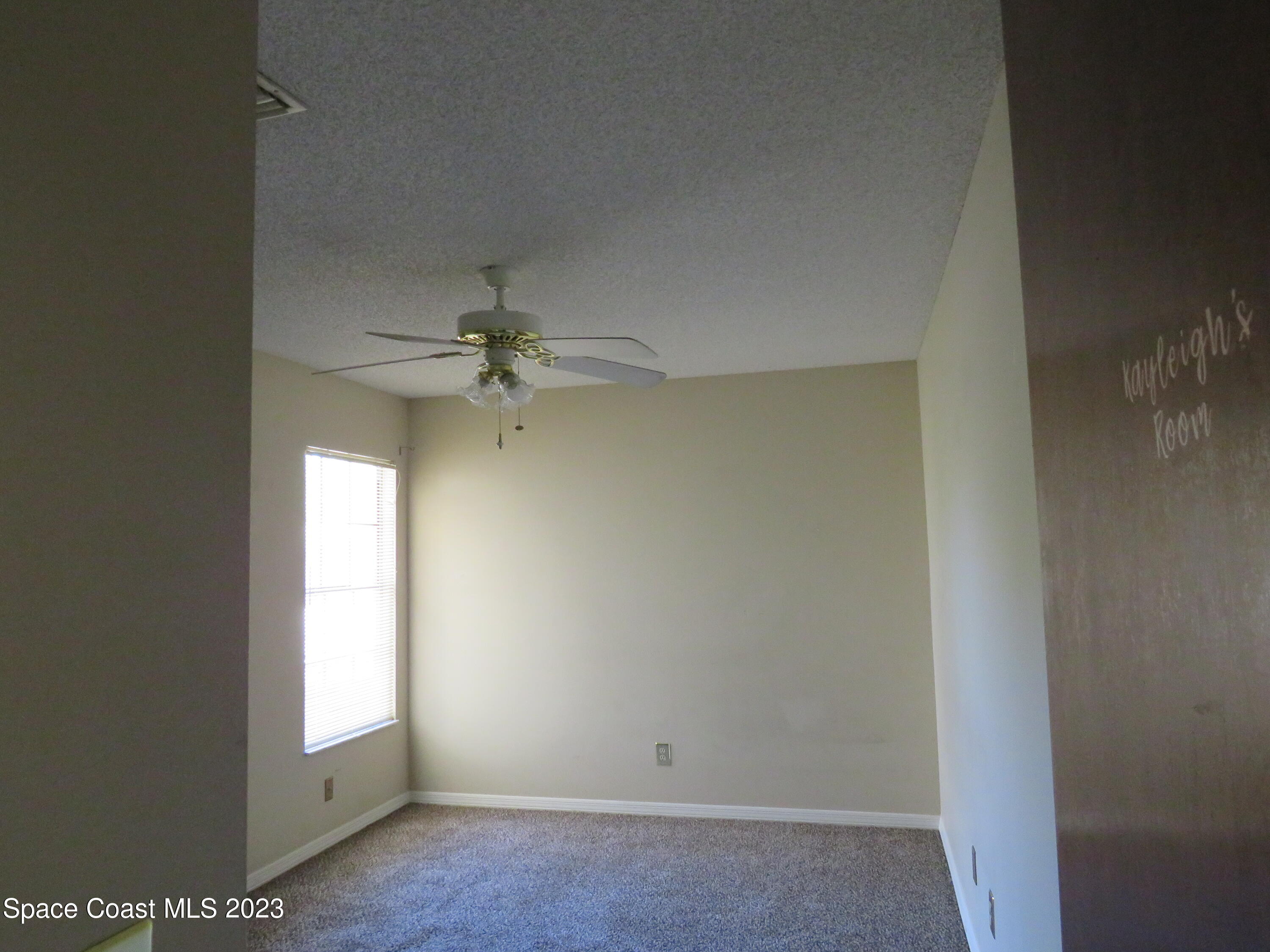 465 Arbor Ridge Lane Titusville, FL 32780 - Photo 7 of 13 an empty room with windows and fan