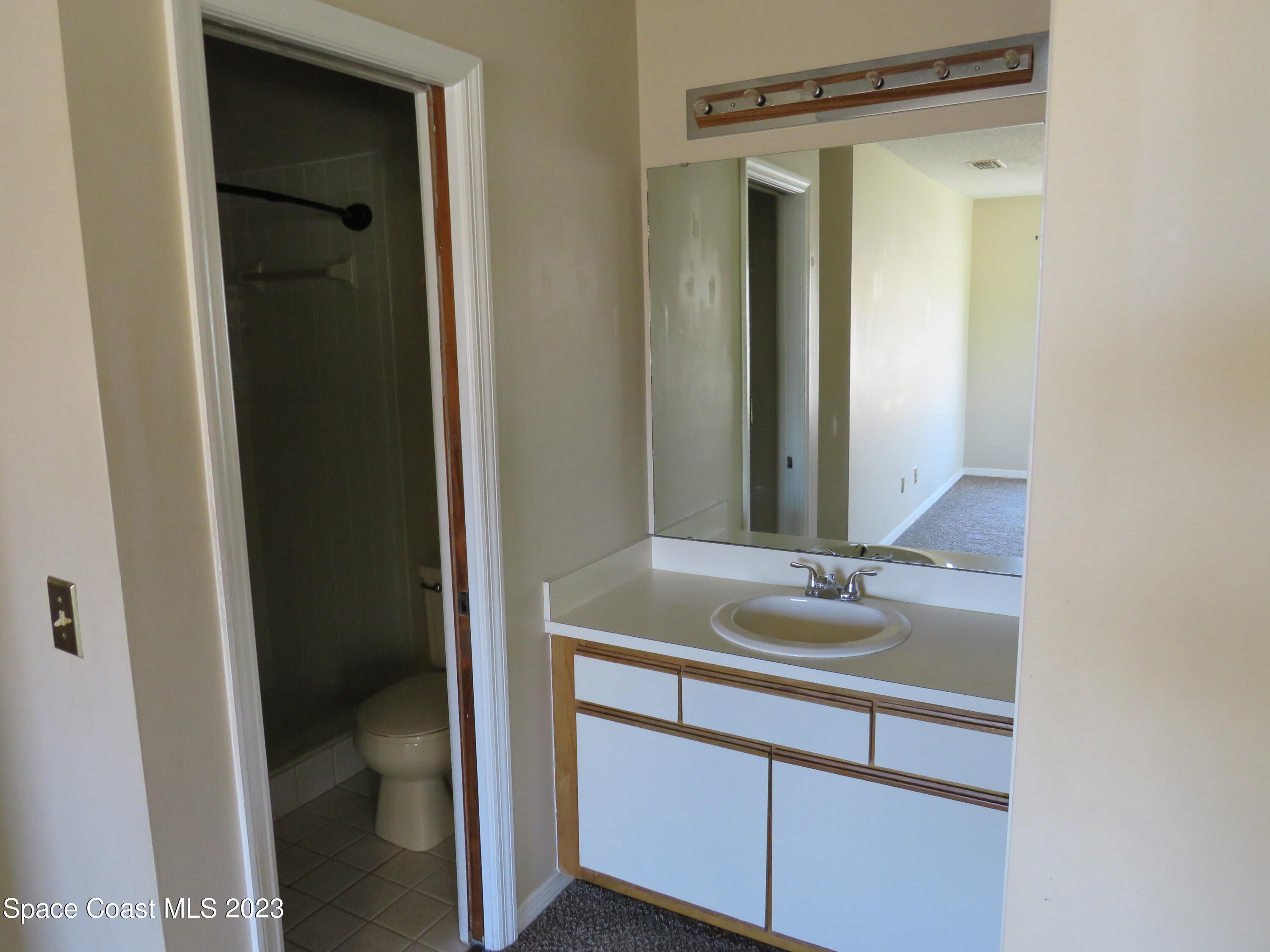 465 Arbor Ridge Lane Titusville, FL 32780 - Photo 9 of 13 a bathroom with a sink and a mirror