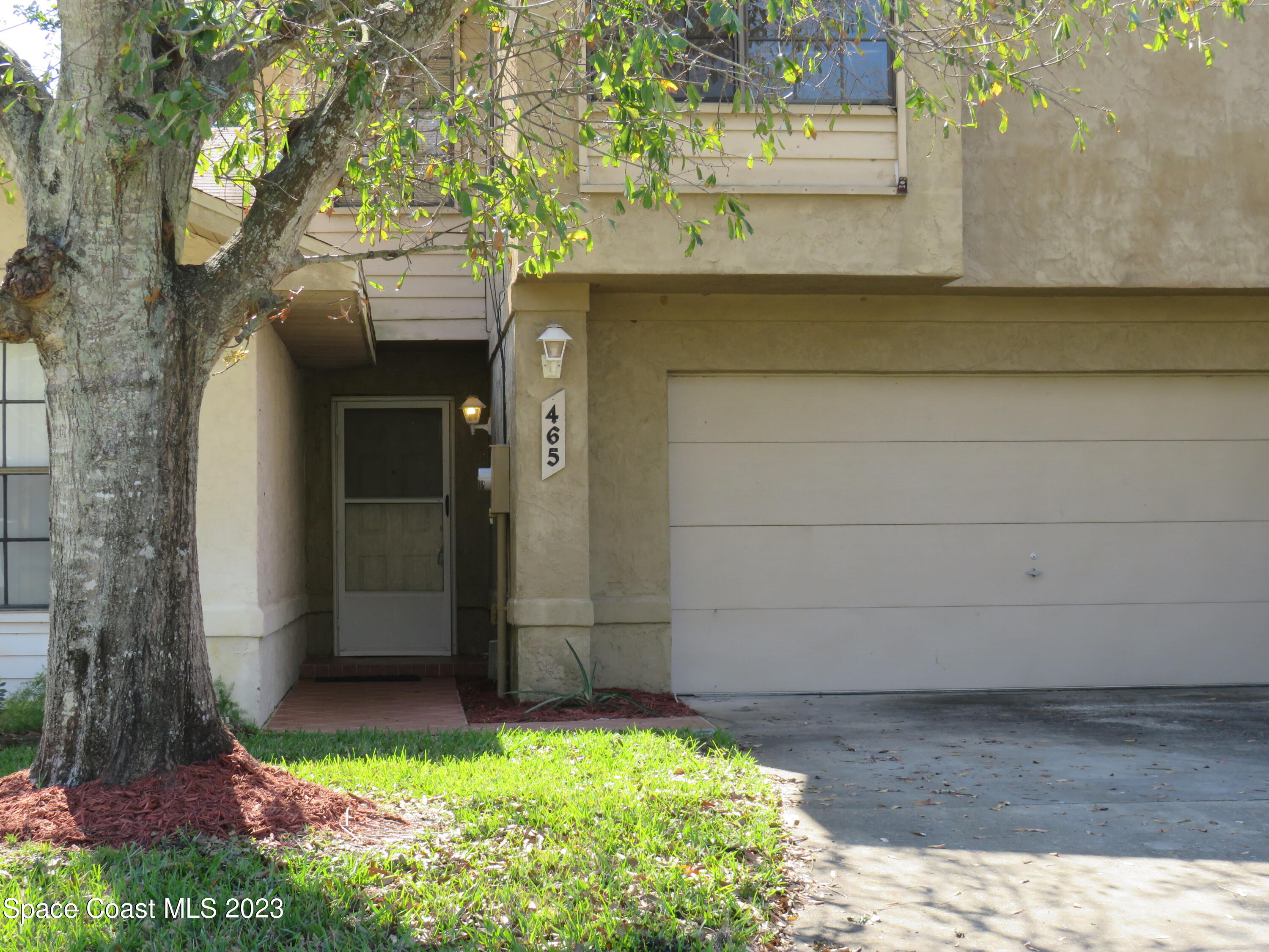 465 Arbor Ridge Lane Titusville, FL 32780 - Photo 10 of 13 a front view of a house with a yard