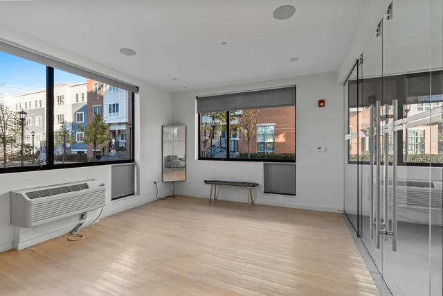 a view of a living room hardwood floor and a large window