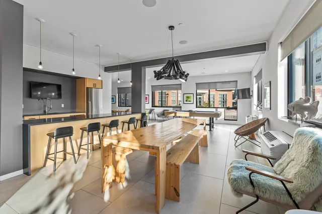 a living room with furniture a flat screen tv and a dining table