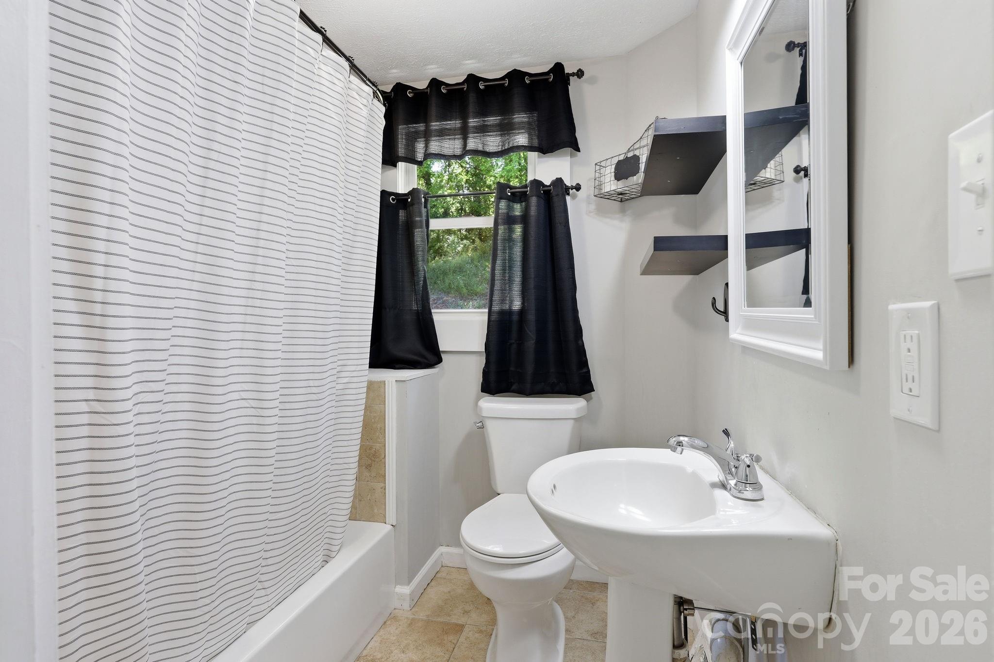 197 Mulberry Street Clyde, NC 28721 - Photo 15 of 31 a bathroom with a sink toilet and shower