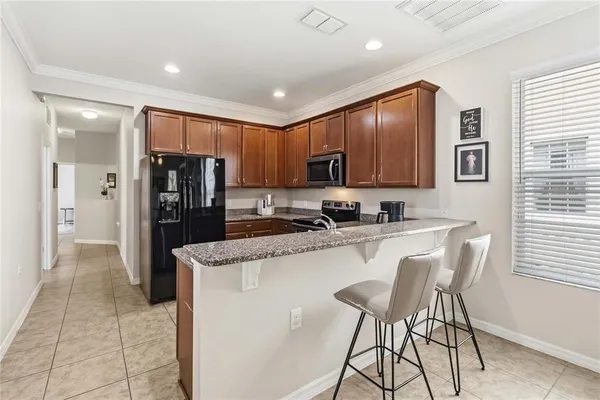 a kitchen with lots of counter top space and two mirrors