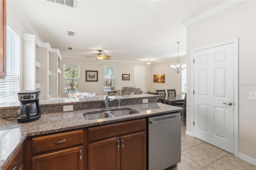 3430 Schoolhouse Road Harmony, FL 34773 - Photo 15 of 70 a kitchen with lots of counter top space and two mirrors