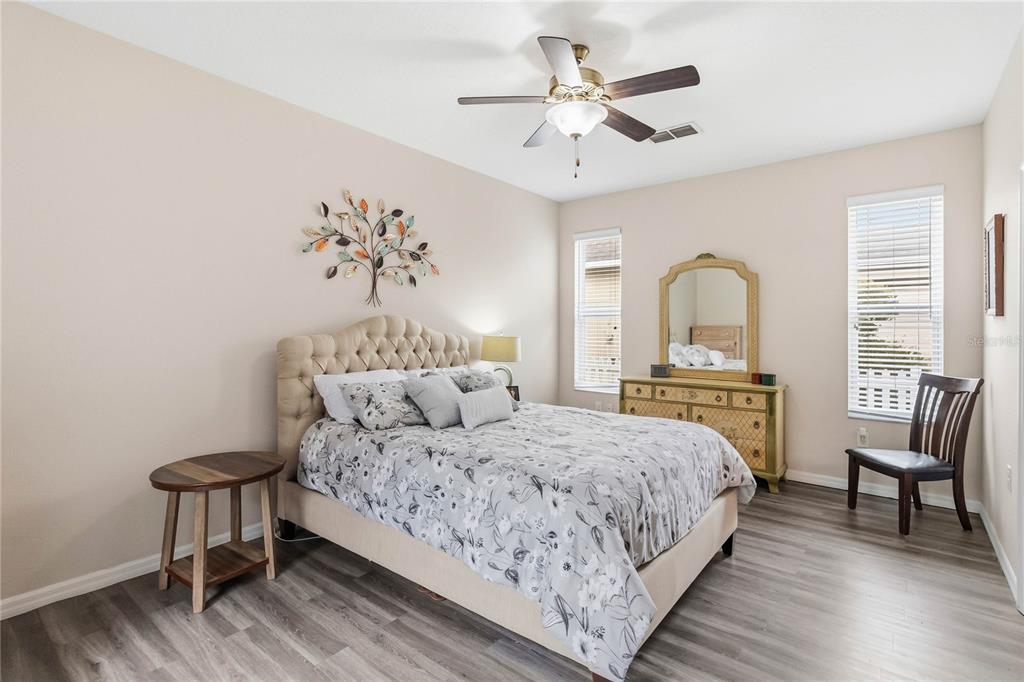 3430 Schoolhouse Road Harmony, FL 34773 - Photo 17 of 70 a bedroom with a bed and a chandelier