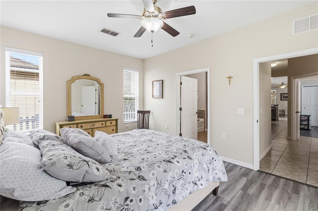 3430 Schoolhouse Road Harmony, FL 34773 - Photo 19 of 70 a bedroom with a large bed and ceiling fan