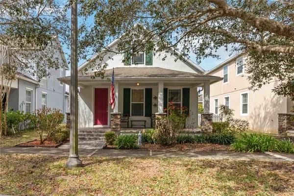 a view of a porch with chairs and floor to ceiling window