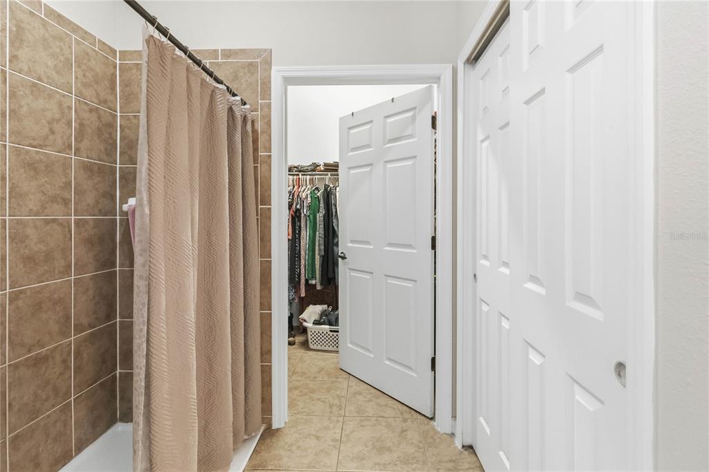 3430 Schoolhouse Road Harmony, FL 34773 - Photo 23 of 70 a bathroom with a shower and a glass door