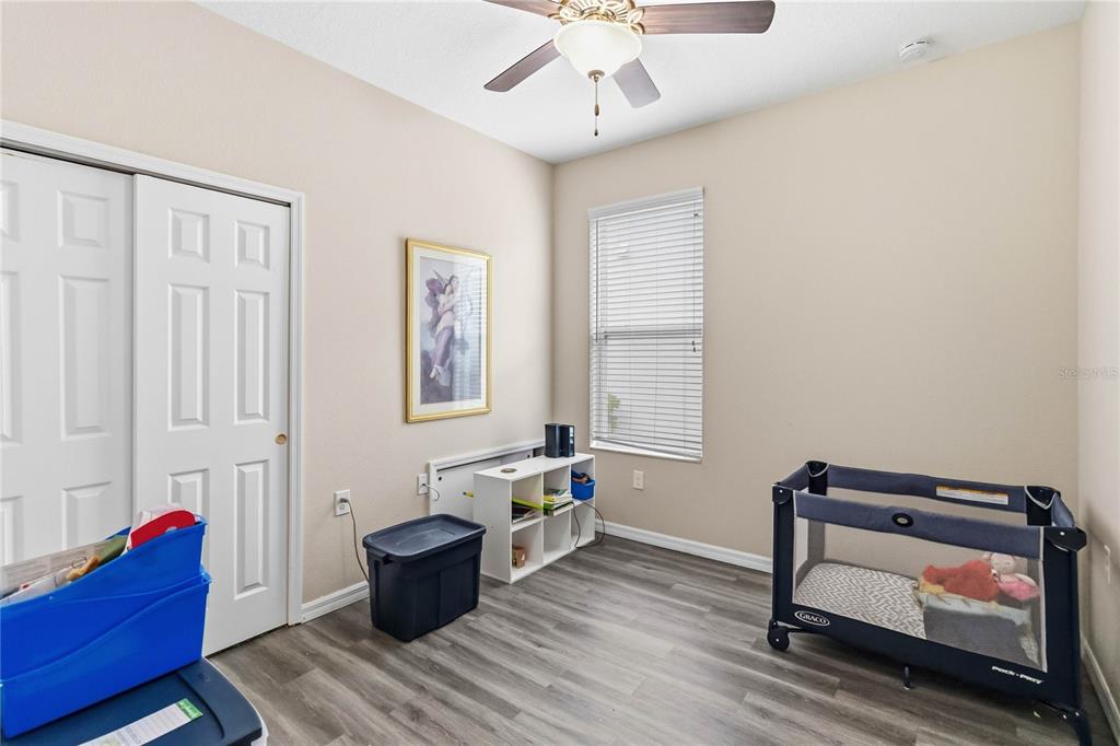 3430 Schoolhouse Road Harmony, FL 34773 - Photo 26 of 70 a living room with furniture and wooden floor