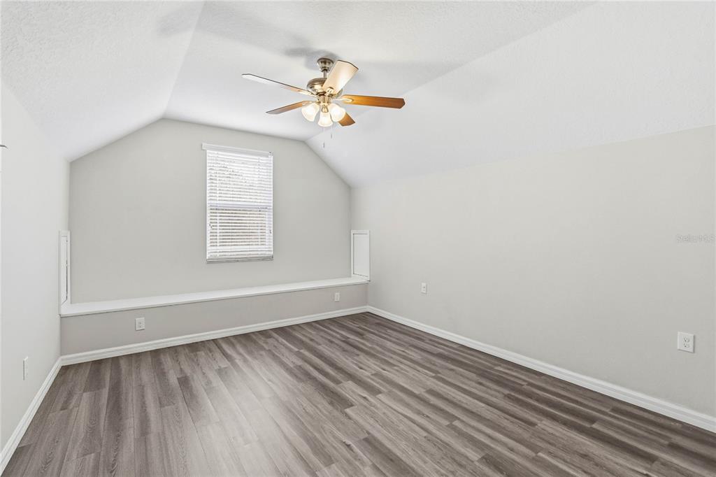 3430 Schoolhouse Road Harmony, FL 34773 - Photo 32 of 70 an empty room with windows and fan