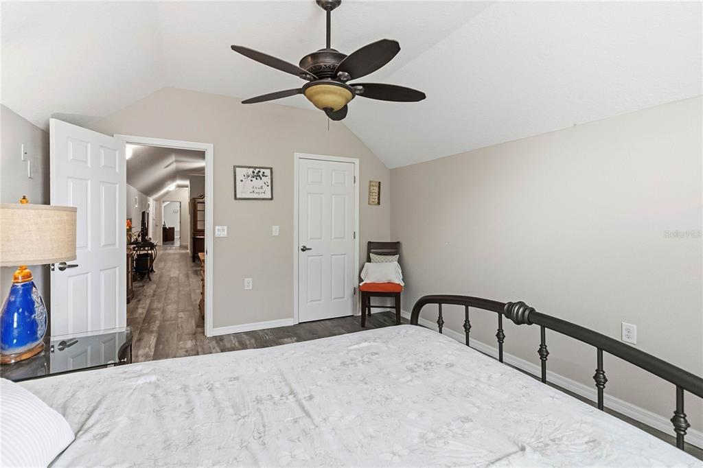 3430 Schoolhouse Road Harmony, FL 34773 - Photo 41 of 70 a bedroom with a bed and a chandelier