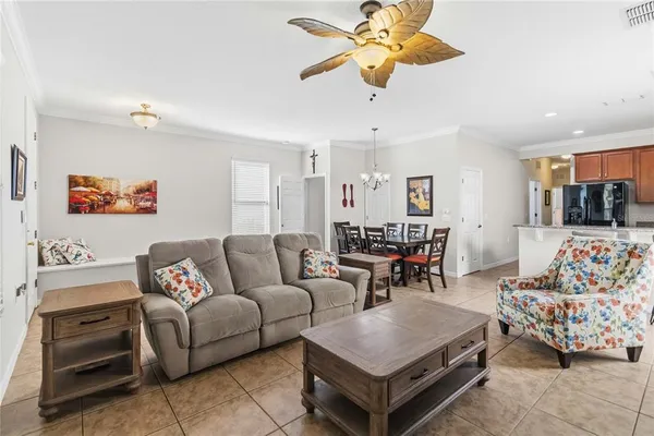 a kitchen with stainless steel appliances granite countertop a refrigerator a stove a sink a dining table and chairs