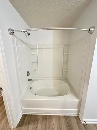 a bathroom with a sink a mirror and a shower