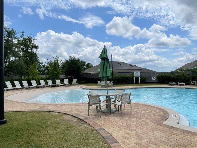 348 Merlin Court Crestview, FL 32539 - Photo 34 of 40 a view of a swimming pool with lawn chairs and a big yard