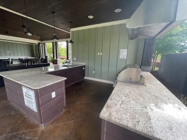 a large kitchen with stainless steel appliances granite countertop a stove and a sink