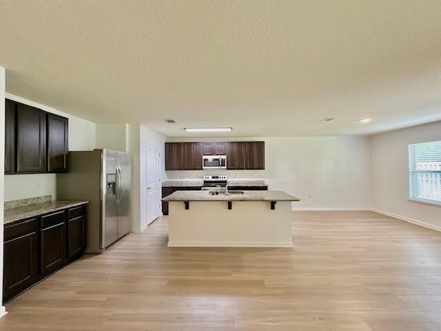 348 Merlin Court Crestview, FL 32539 - Photo 6 of 40 a view of kitchen with microwave stove refrigerator and cabinets