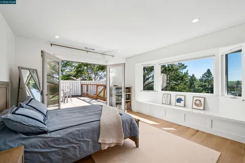 a bedroom with a bed and large window