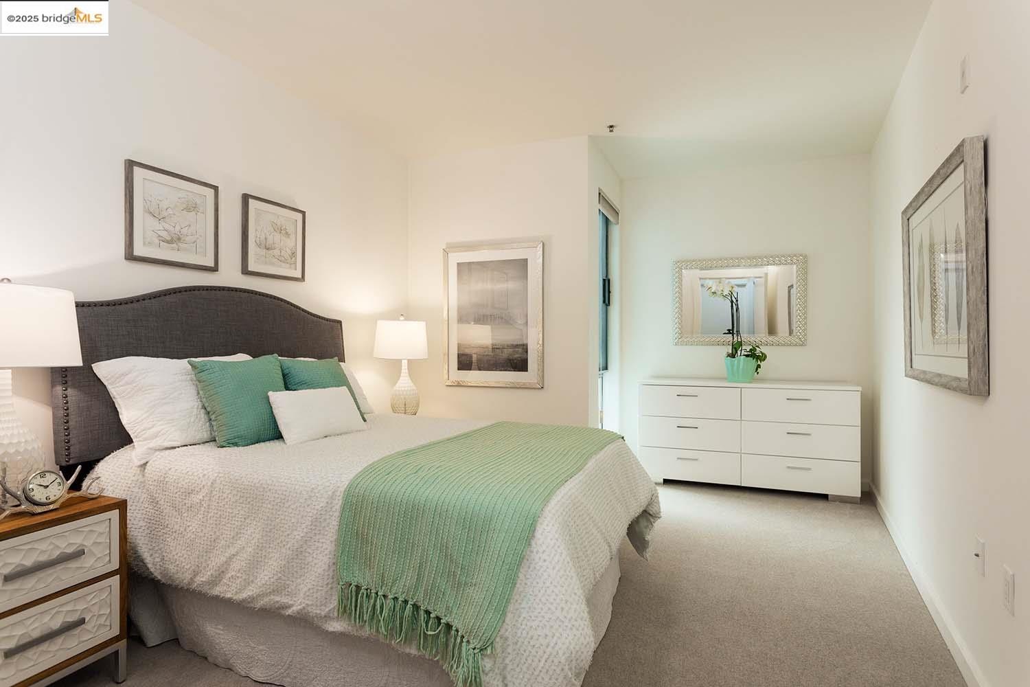 200 2nd Street, Unit 215 Oakland, CA 94607 - Photo 11 of 18 a bedroom with a bed and a couch