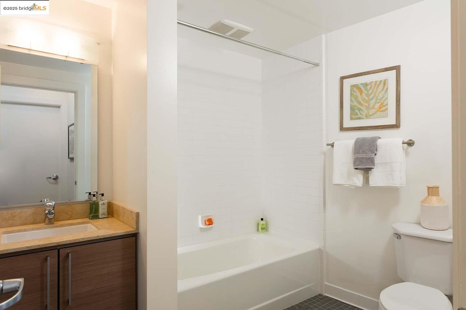 200 2nd Street, Unit 215 Oakland, CA 94607 - Photo 12 of 18 a bathroom with a sink and a mirror