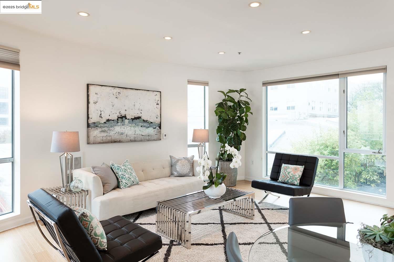 200 2nd Street, Unit 215 Oakland, CA 94607 - Photo 2 of 18 a living room with furniture and a large window