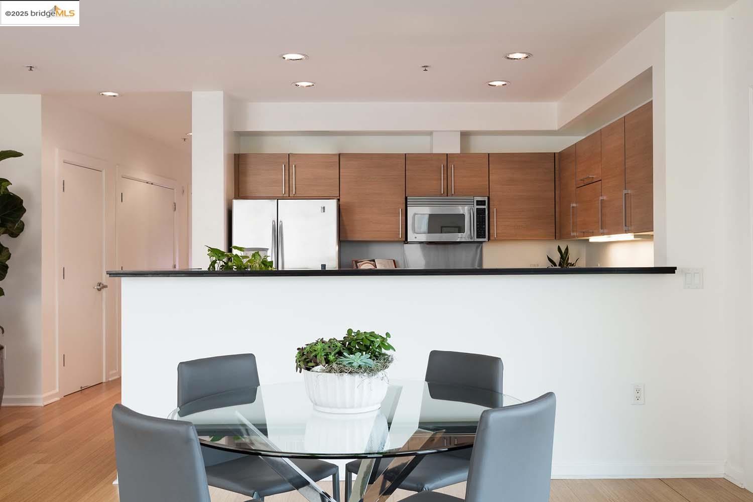 200 2nd Street, Unit 215 Oakland, CA 94607 - Photo 4 of 18 a living room with furniture kitchen view and a potted plant