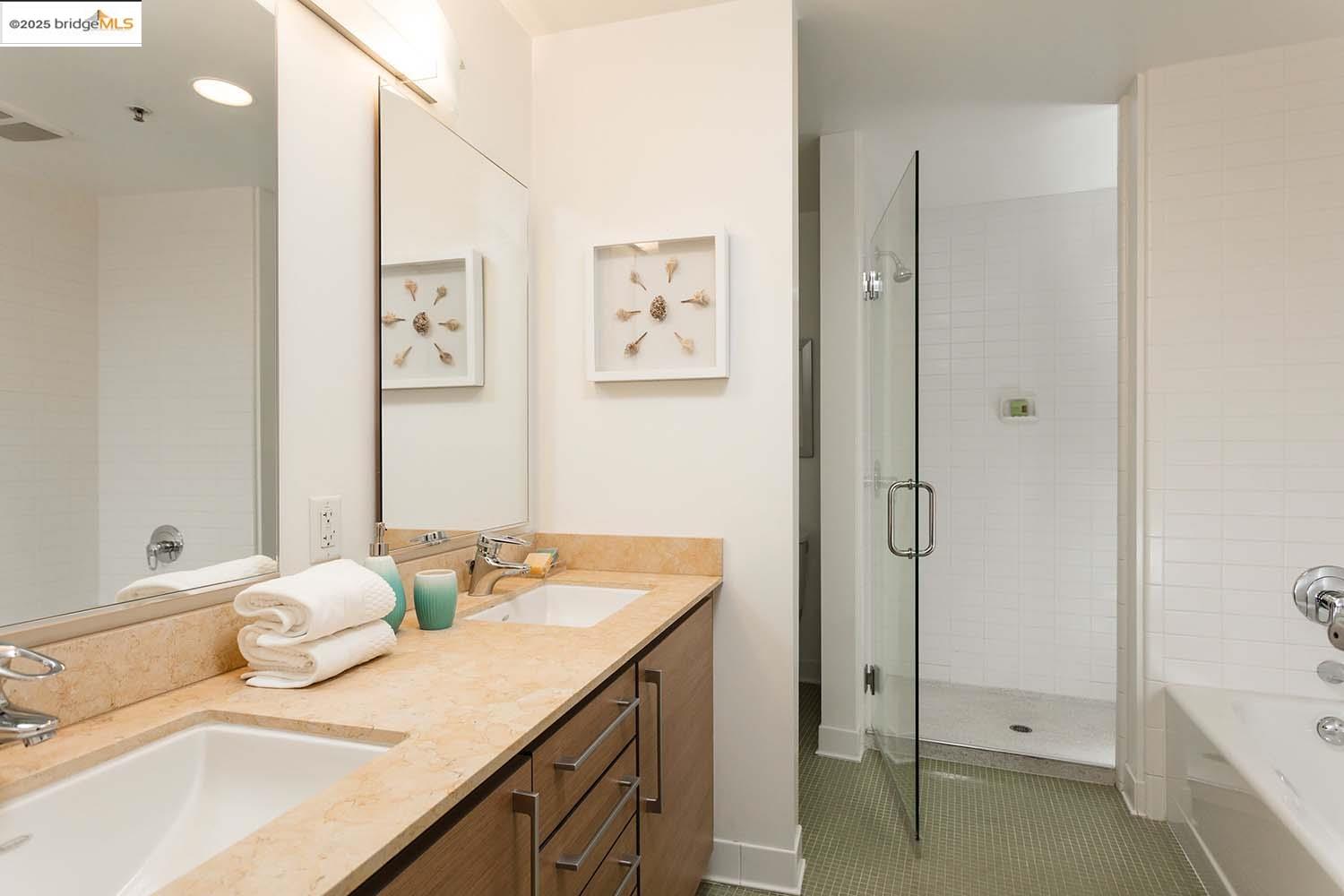 200 2nd Street, Unit 215 Oakland, CA 94607 - Photo 9 of 18 a bathroom with a granite countertop sink a toilet and shower