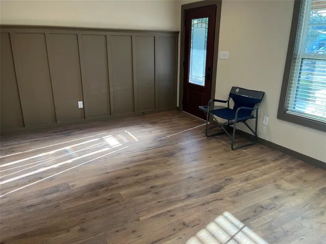 a view of wooden floor and windows in a room