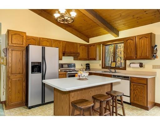 50 Deer Bay Road Ashby, MA 01431 - Photo 19 of 40 a kitchen with stainless steel appliances a sink a stove a refrigerator cabinets and a dining table
