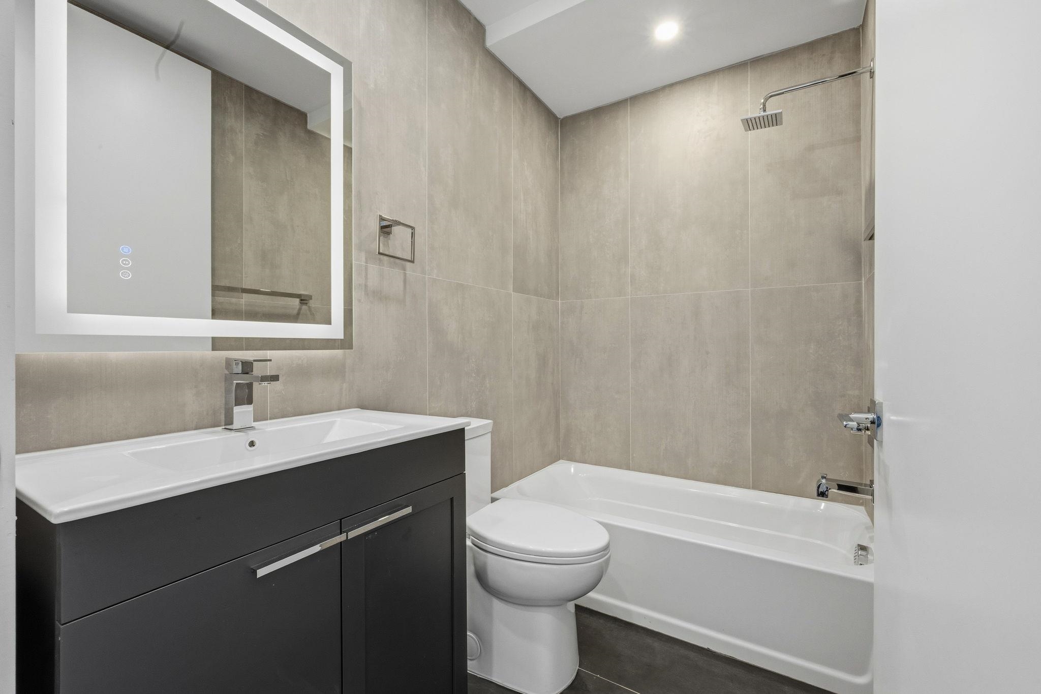 77 Van Reypen Street, Unit 4 Jersey City, NJ 07306 - Photo 13 of 23 a bathroom with a sink a toilet and shower