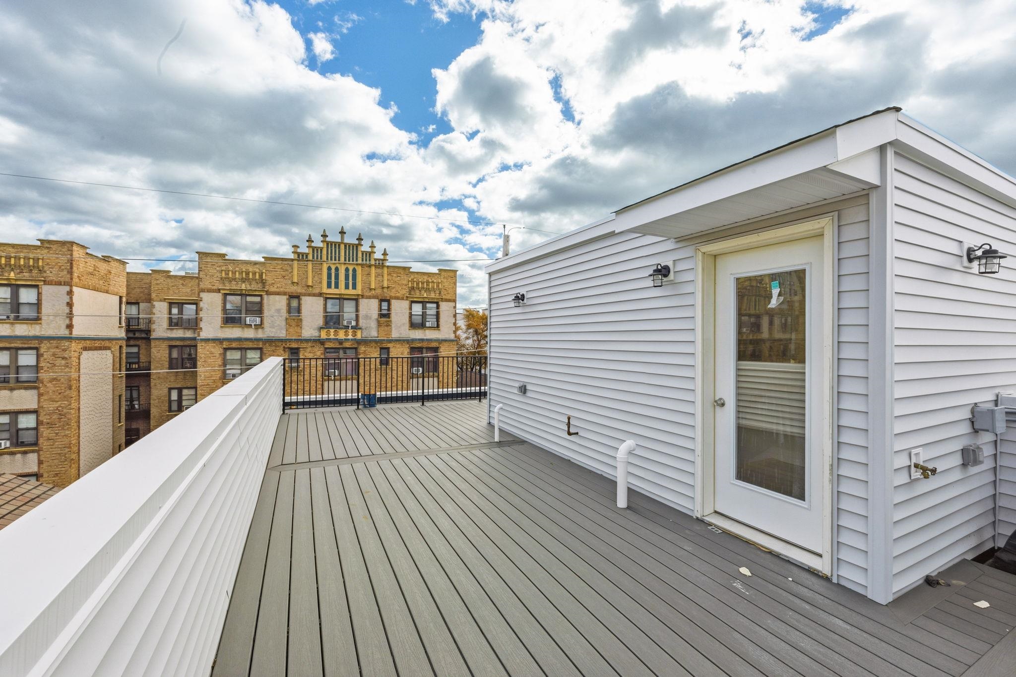77 Van Reypen Street, Unit 4 Jersey City, NJ 07306 - Photo 18 of 23 a view of a balcony with wooden floor