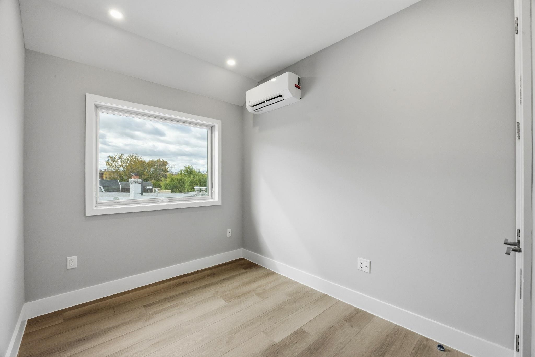 77 Van Reypen Street, Unit 4 Jersey City, NJ 07306 - Photo 10 of 23 a view of an empty room with a window and closet area
