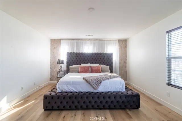 a bedroom with a bed and a window