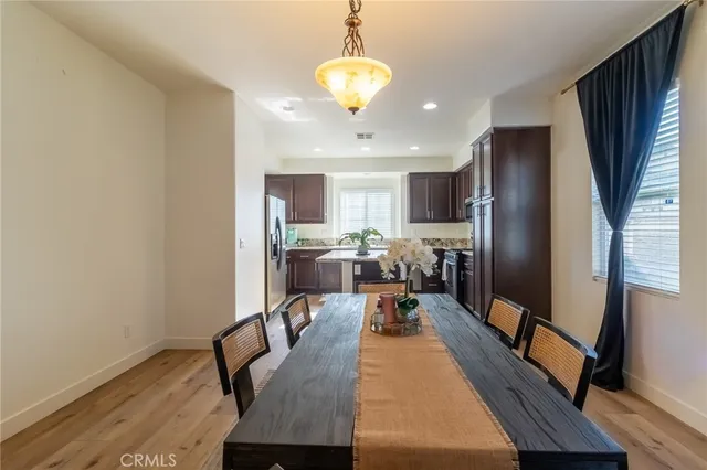 a living room with dining table furniture and a chandelier